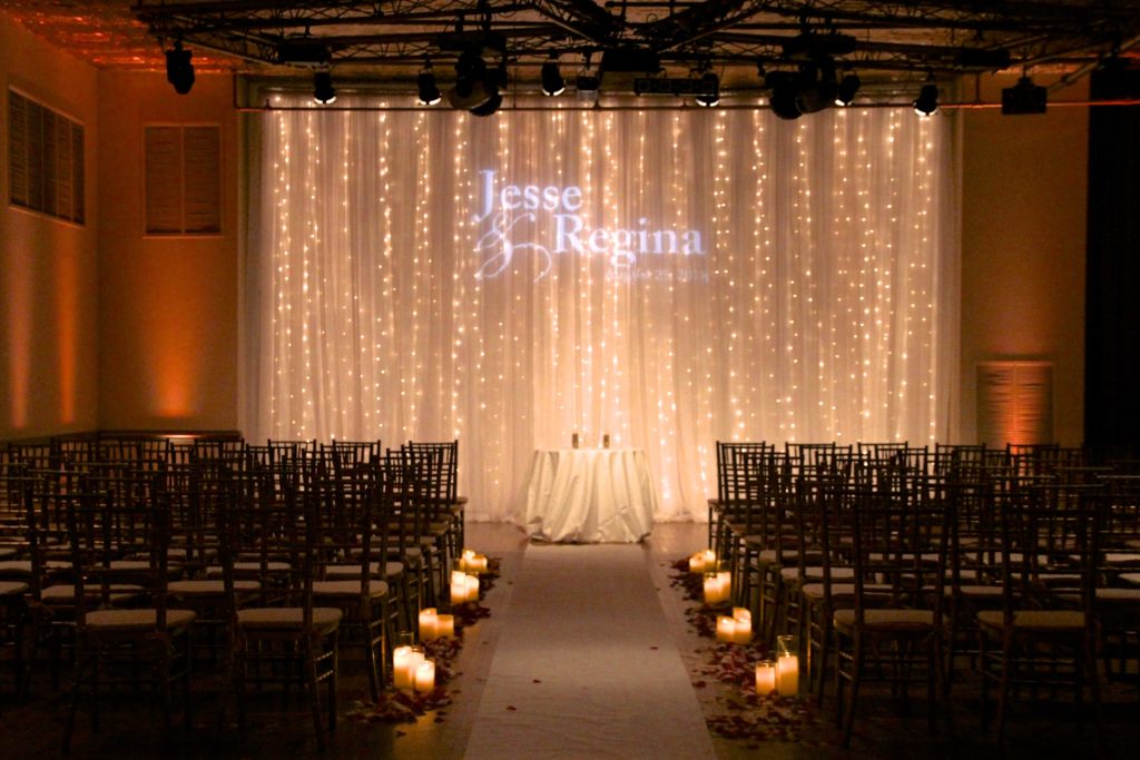 wedding aisle backdrop with sparkle lighting and monogram